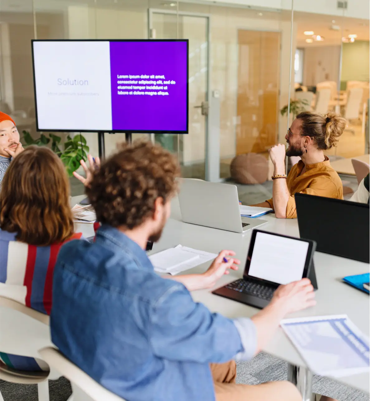 People sitting around a desk looking at a computer